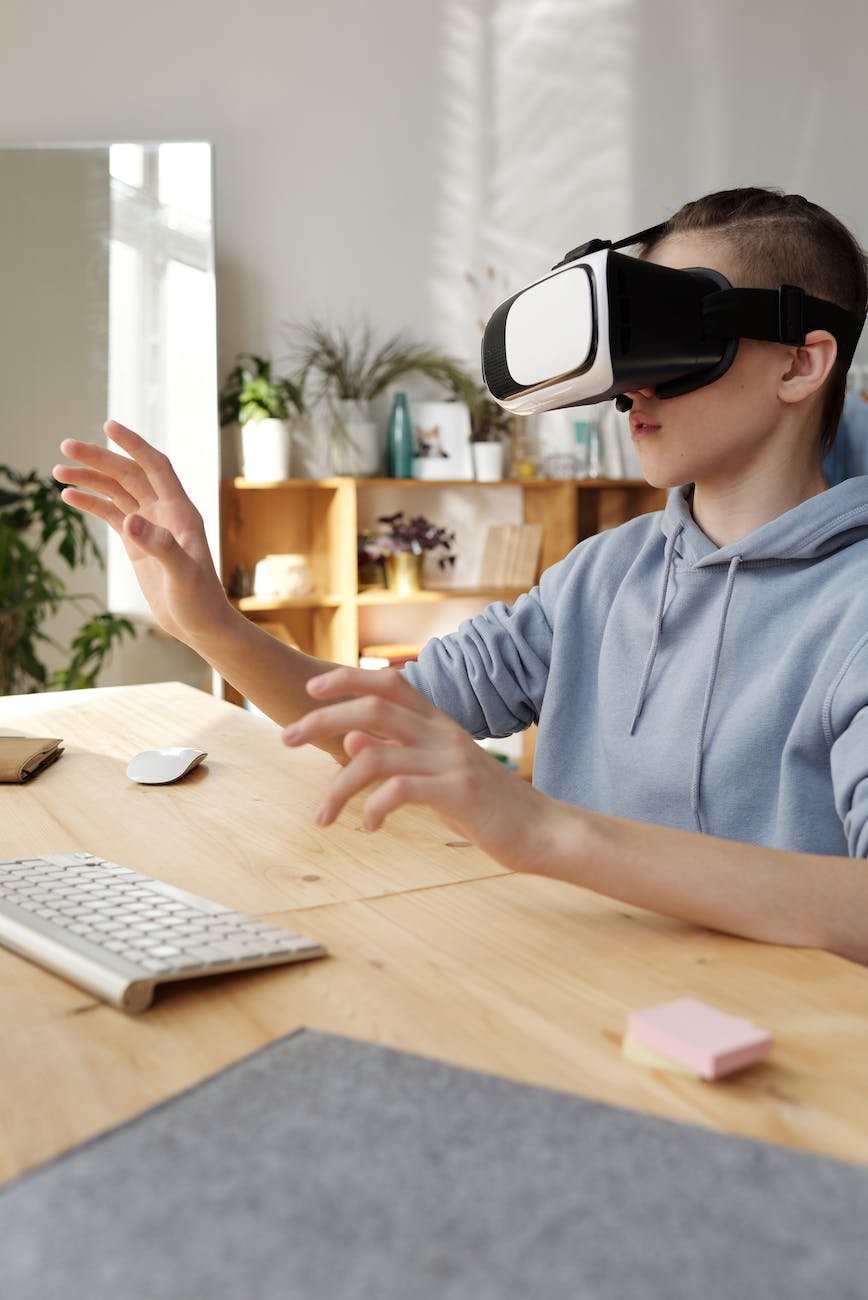 boy in gray hoodie wearing vr headset